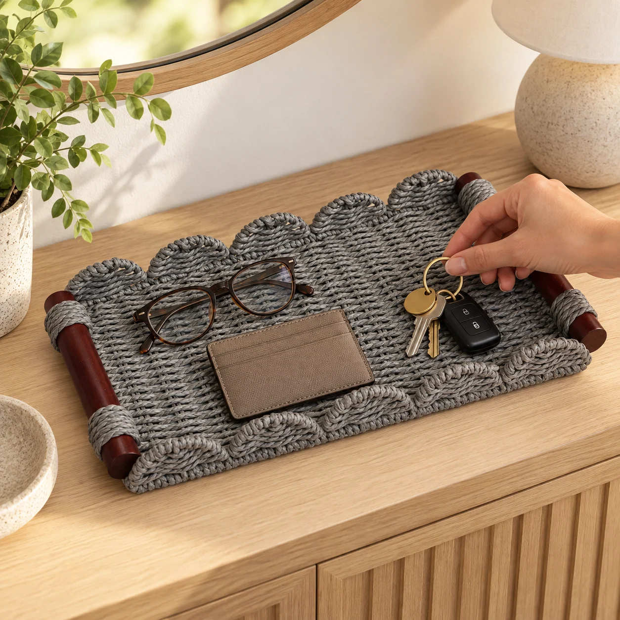 Gray tray holding glasses, a cardholder, and keys